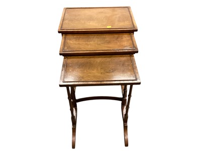 Lot 1298 - Nest of three walnut occasional tables