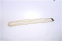 Lot 666 - Cultured pearl two-strand necklace, with two...