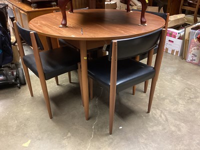 Lot 1250 - Mid century teak extending dining table with extra leaf, 117cm diameter, together with four dining chairs