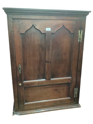 Lot 1310 - 18th century oak hanging corner cupboard with arched panelled goor enclosing shelves 93cm high, 70cm wide, 29.6cm deep