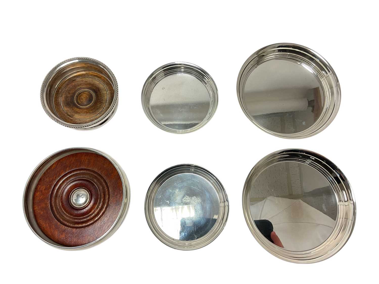 Lot 265 - Set of four graduated silver coasters and two further with turned wo...