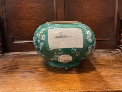 Lot 104 - Unusual Chinese stoneware planter, probably early 20th century, of oblong form, painted with grisaille panels on a green floral ground, 19.5cm high x 32cm wide