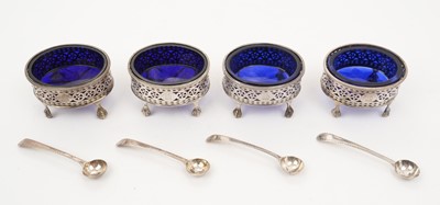 Lot 277 - Set of four Georgian oval salts on paw feet, with blue glass liners and spoons