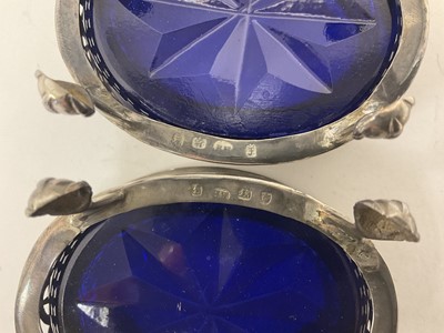 Lot 277 - Set of four Georgian oval salts on paw feet, with blue glass liners and spoons