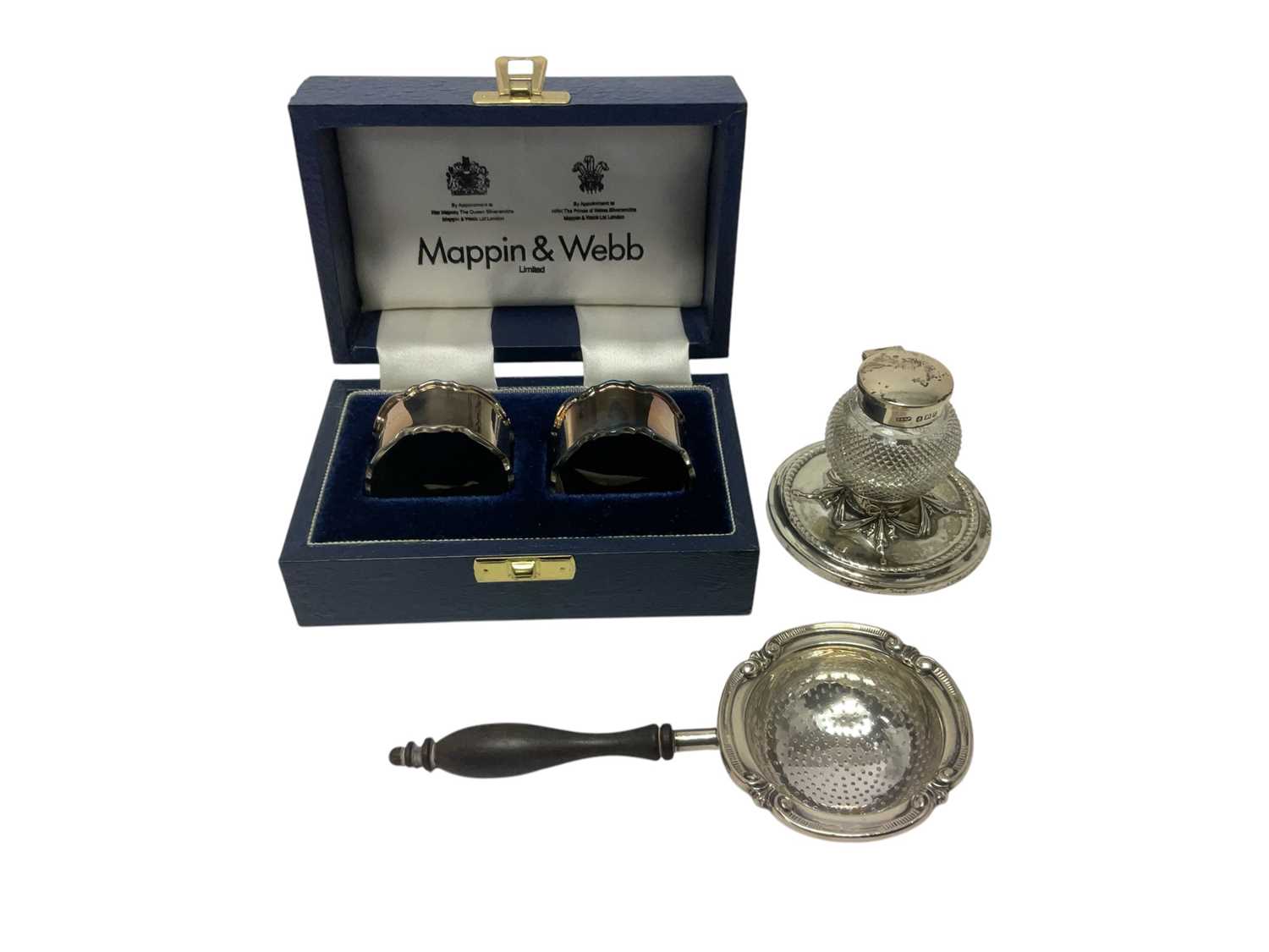 Lot 278 - Cased silver napkin rings together with a tea strainer and silver cut glass ink well