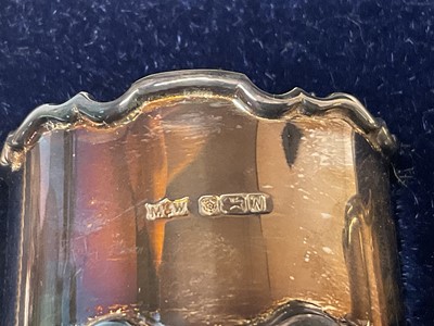 Lot 278 - Cased silver napkin rings together with a tea strainer and silver cut glass ink well