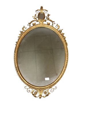 Lot 1326 - Decorative oval wall mirror in ornate gilt frame, 109cm x 59cm