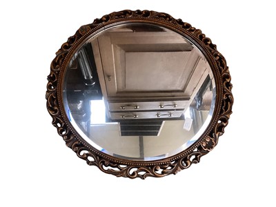 Lot 1327 - Circular bevelled wall mirror in carved and pierced oak frame, 59cm diameter