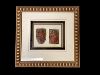 Lot 297 - Pair of framed Ivory Coast passport masks, together with a mixed media abstract of a clown, a photograph of Billingsgate fish market, a Haiti voodoo picture, and a collection of London Evening S...