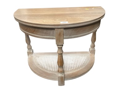 Lot 1351 - Limed oak two tier demi lune occasional table with caned panel