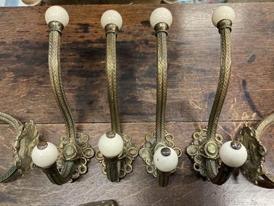 Lot 225 - Set of six large Victorian brass coat hooks with ceramic terminals, plus one other (7)
