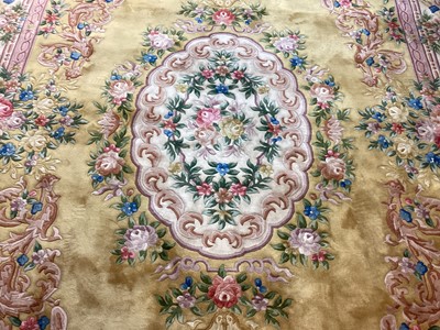 Lot 1408 - Large Chinese wool pile rug with floral decoration on yellow and pink ground, 372cm x 278cm