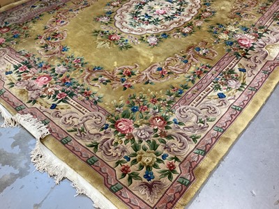 Lot 1408 - Large Chinese wool pile rug with floral decoration on yellow and pink ground, 372cm x 278cm