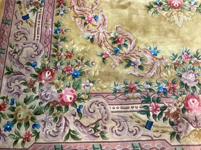 Lot 1408 - Large Chinese wool pile rug with floral decoration on yellow and pink ground, 372cm x 278cm
