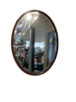 Lot 1415 - Oval bevelled wall mirror in wooden frame