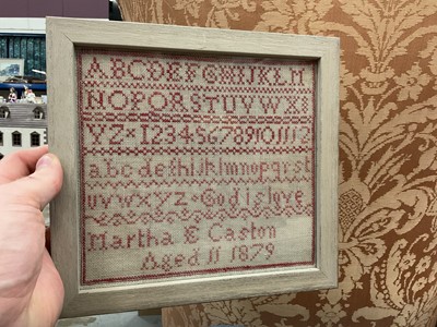 Lot 568 - Victorian needlework alphabet sampler by Martha E Caston, Aged 11, 1879, mounted in glazed frame.