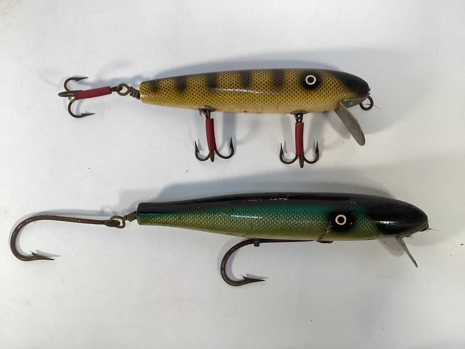 Lot 1198 - Two unusual very large carved wood and brightly painted fishing lures, 26cm and 21cm long