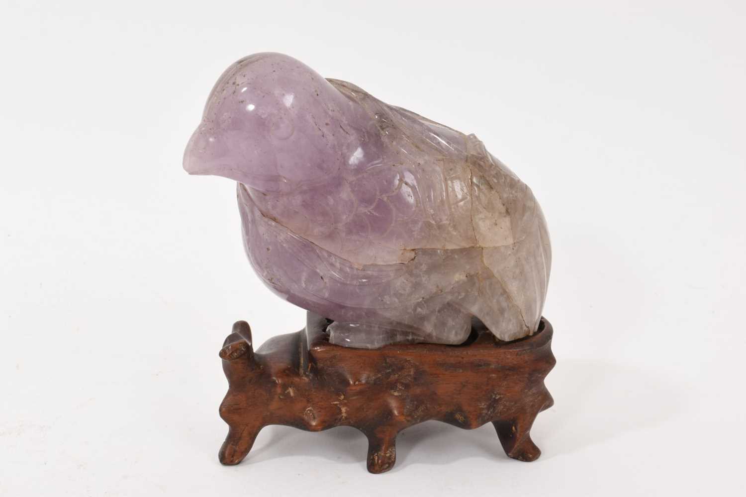 Lot 866 - Antique Chinese carved amethyst figure of a bird, on hardwood stand