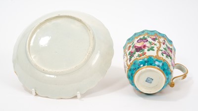 Lot 28 - An unusual Worcester fluted porcelain cup and saucer, circa 1770, painted in enamels with fruit and insects, with gilt and turquoise scroll borders, the saucer 13.5cm diameter