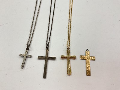 Lot 1050 - Two 9ct gold cross pendants, one on chain and two silver cross pendants on chains