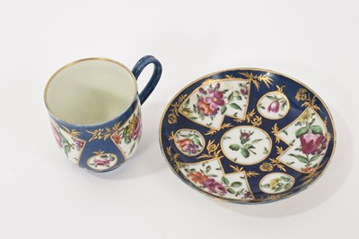 Lot 36 - A Worcester coffee cup and saucer, circa 1765, polychrome painted with flowers in fan-shaped panels, on a powder blue ground, the saucer 11.5cm diameter
