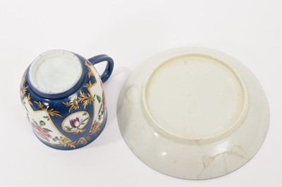 Lot 36 - A Worcester coffee cup and saucer, circa 1765, polychrome painted with flowers in fan-shaped panels, on a powder blue ground, the saucer 11.5cm diameter