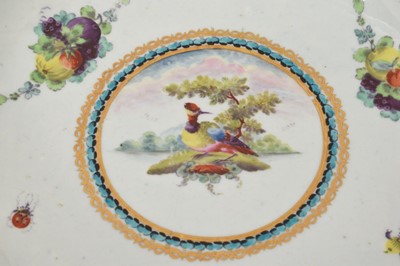 Lot 34 - A Worcester 'Lord Rodney' type saucer dish, circa 1770, painted with a colourful bird, swags of fruit and insects, with gilded blue edges, 16cm diameter