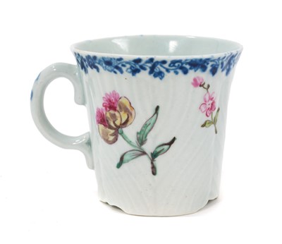 Lot 2 - A Worcester coffee can, circa 1755, of feather-moulded, tapering form with an ear-shaped handle, London-painted with colourful European flowers beneath an underglaze blue fol...