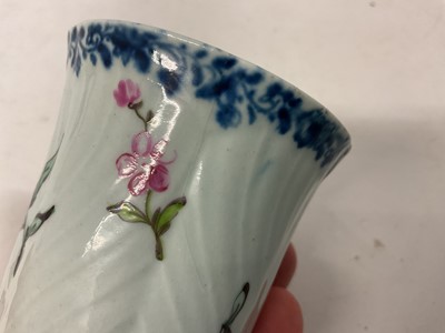 Lot 2 - A Worcester coffee can, circa 1755, of feather-moulded, tapering form with an ear-shaped handle, London-painted with colourful European flowers beneath an underglaze blue fol...