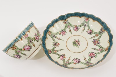 Lot 27 - A Worcester fluted tea bowl and saucer, circa 1775, polychrome painted with swags of flowers in Hop Trellis style, on turquoise scale ground, the saucer 13.5cm diameter, together with a Queen's...