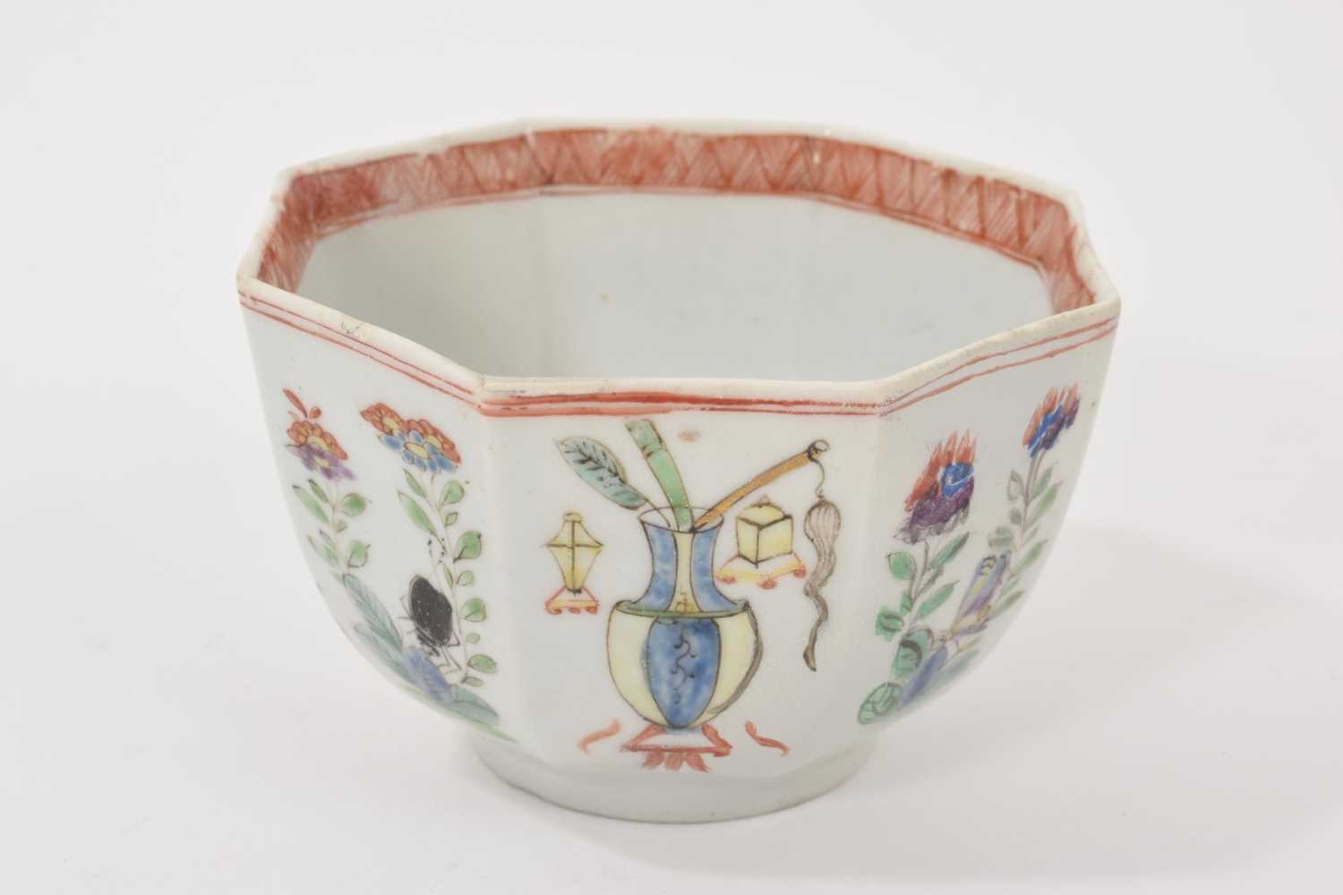 Lot 5 - A Worcester octagonal tea bowl, circa 1755, polychrome painted in the Chinese style with alternating panels of flowers and vases, 7cm wide
