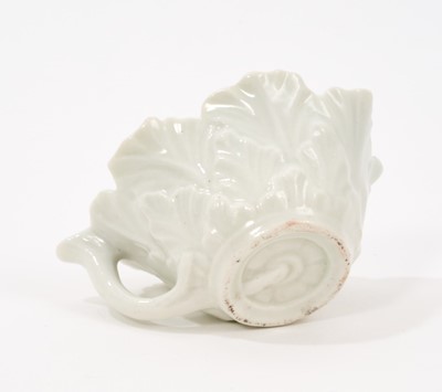 Lot 12 - A Worcester polychrome leaf-shaped butterboat, circa 1758, with branch handle, painted to the well with scattered polychrome sprigs and flowers, the exterior moulded with overlapping leaves, 8.5...