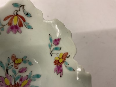 Lot 12 - A Worcester polychrome leaf-shaped butterboat, circa 1758, with branch handle, painted to the well with scattered polychrome sprigs and flowers, the exterior moulded with overlapping leaves, 8.5...