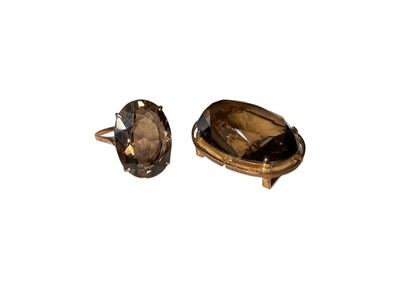 Lot 4 - Large oval mixed cut smoky quartz cocktail ring in yellow metal setting, size R and a similar costume brooch (2)