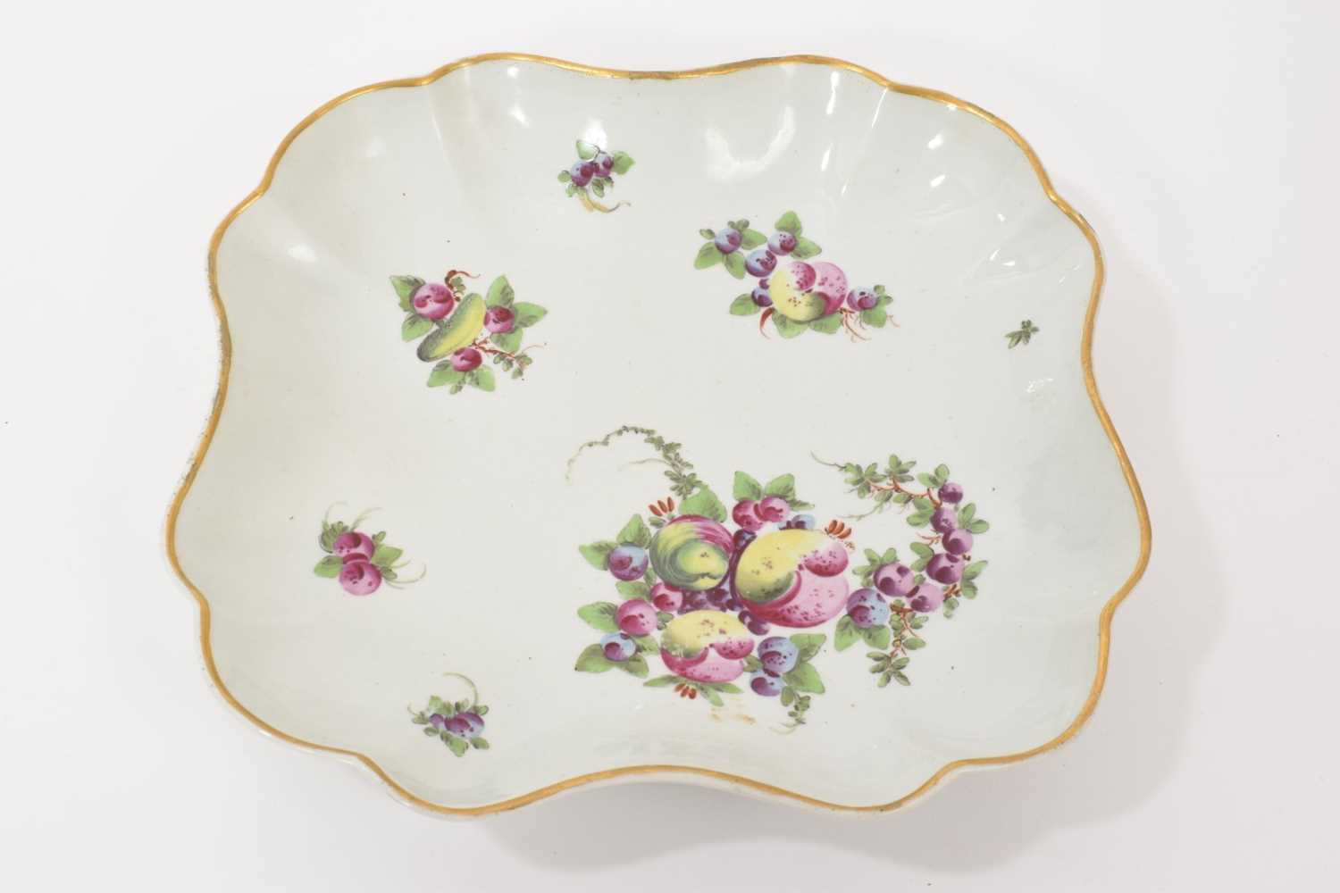 Lot 19 - A Worcester dish, circa 1770, of square scalloped form, polychrome painted with spotted fruit, gilt rim, 20cm across Ex-Crane Collection