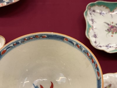 Lot 65 - A rare Worcester tea bowl and saucer, circa 1765-70, painted in the Candle Fence Pavilion pattern and clobbered at the factory, crescent marks, the saucer 12.5cm diameter