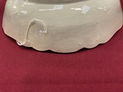 Lot 23 - Rare and early Worcester blue and white junket dish, circa 1758, painted with three landscape panels in the Neighbours pattern on a basket-weave moulded ground, the shaped rim with flowers and...