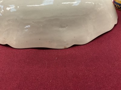 Lot 23 - Rare and early Worcester blue and white junket dish, circa 1758, painted with three landscape panels in the Neighbours pattern on a basket-weave moulded ground, the shaped rim with flowers and...