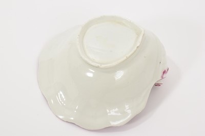 Lot 13 - A Worcester shell-shape sweetmeat dish, circa 1758, painted with a spray of flowers, scattered sprigs, within a puce border 12cm wide