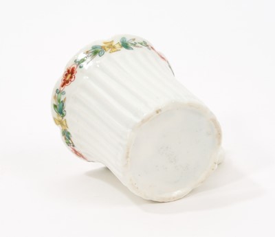 Lot 8 - An early Worcester coffee can, circa 1754-55, of elegant reeded form, with flared indented rim, bevelled base and scroll handle, the border painted with flowers in the famille verte style, 5.6cm...
