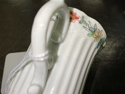 Lot 8 - An early Worcester coffee can, circa 1754-55, of elegant reeded form, with flared indented rim, bevelled base and scroll handle, the border painted with flowers in the famille verte style, 5.6cm...