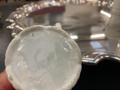 Lot 8 - An early Worcester coffee can, circa 1754-55, of elegant reeded form, with flared indented rim, bevelled base and scroll handle, the border painted with flowers in the famille verte style, 5.6cm...