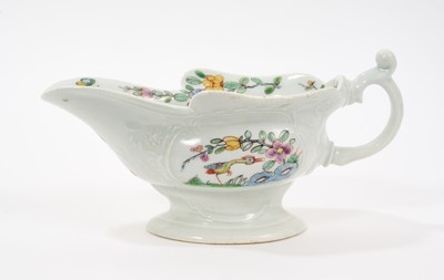 Lot 9 - An early Worcester moulded sauceboat, circa 1753-54, finely painted in polychrome enamels with birds amongst trees and rockwork in the Chinese style, within moulded cartouches on each side, flow...