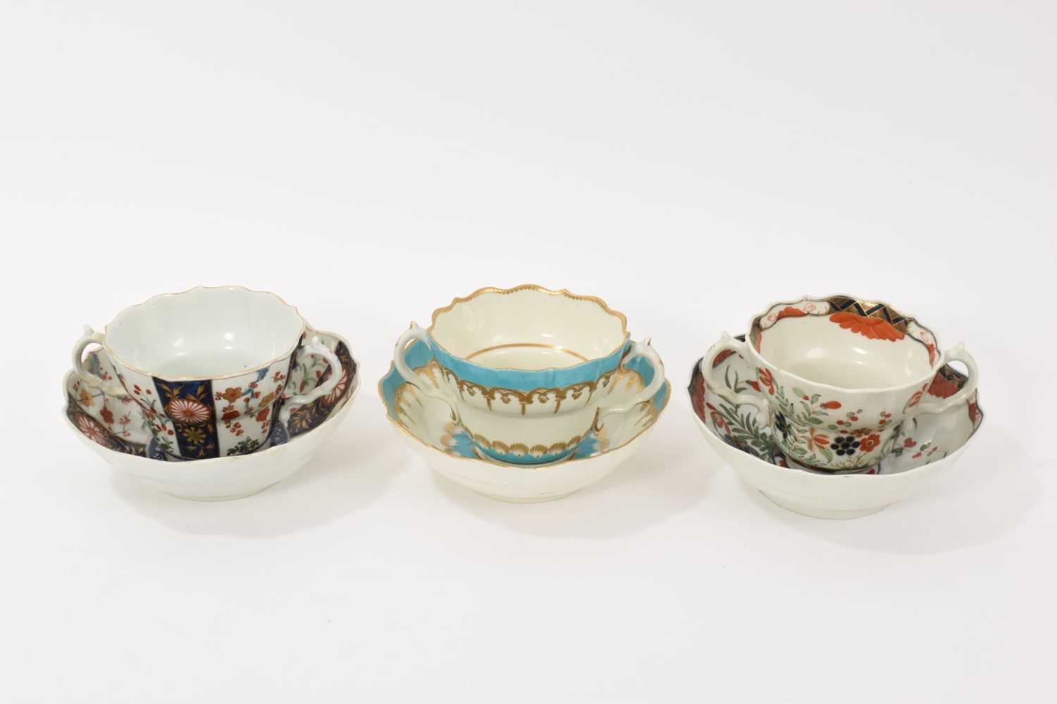 Lot 30 - Three Worcester chocolate cups and saucers, circa 1770, the first decorated in the Queen's pattern, the second Kempthorne (all four pieces with square marks), and the third in turquoise and gilt...