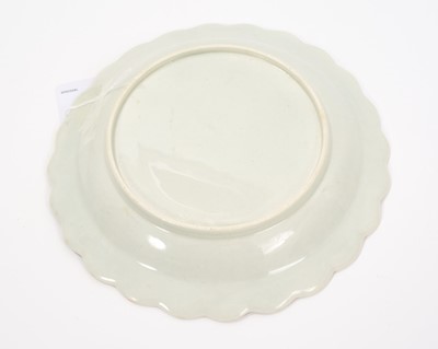 Lot 22 - A Worcester Blind Earl plate, circa 1770, moulded and painted with a rosebud and leaves, painted in between with small sprays of flowers and scattered leaves, the scalloped rim with a gilt C scro...