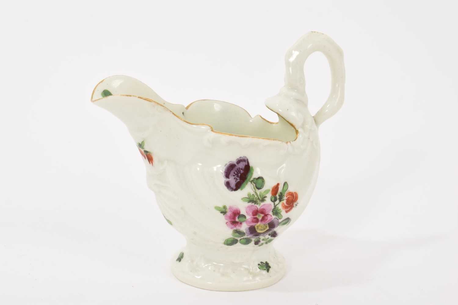 Lot 24 - A Worcester Dolphin Ewer cream boat, circa 1770, with crisp moulding, polychrome painted with floral sprays, gilt rim, 8.25cm high