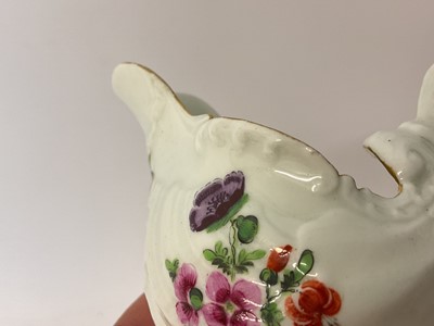 Lot 24 - A Worcester Dolphin Ewer cream boat, circa 1770, with crisp moulding, polychrome painted with floral sprays, gilt rim, 8.25cm high