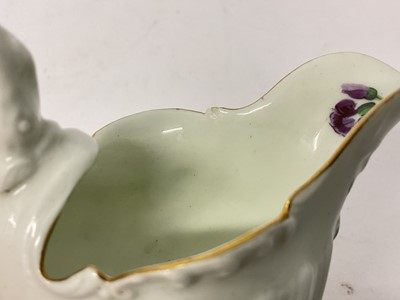 Lot 24 - A Worcester Dolphin Ewer cream boat, circa 1770, with crisp moulding, polychrome painted with floral sprays, gilt rim, 8.25cm high