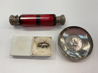 Lot 1006 - Victorian ruby cut glass double-ended scent bottle, Chinese silver coin dish and a silver miniature hippopotamus (3)