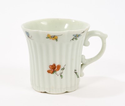Lot 10 - An early Worcester coffee can, circa 1754-55, of elegant reeded form, with flared indented rim, bevelled base and scroll handle, painted with flowers and insects in the famille verte style, 5.5c...